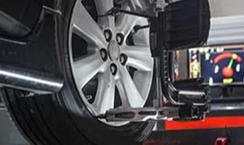 Wheel alignment sensor clamped to a tire