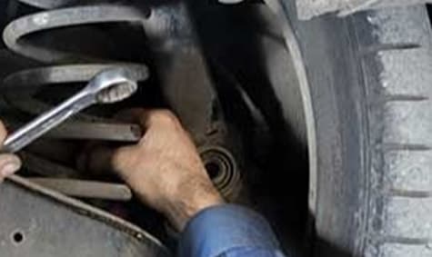 Mechanic working on a coil spring suspension