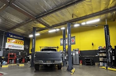 Pickup truck on a two-post lift